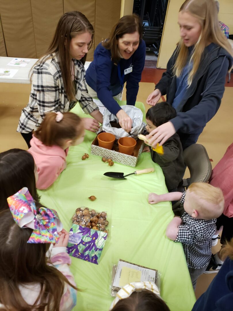 volunteers teaching gardening and pottery with children at church